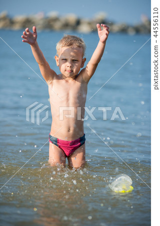 Cute little kid wearing mask and flippers for diving at sand tropical beach. Cute little kid wearing mask and flippers for diving at sand tropical beach. 44556110