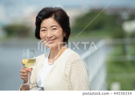 Senior woman wine lifestyle image 44556334