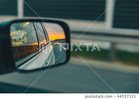 car on highway. sunset in car mirror reflection 44557315