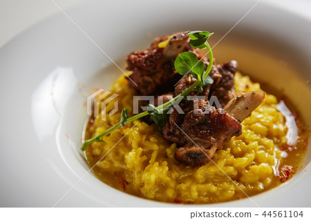 The ossobuco and saffron risotto. Shallow dof The ossobuco and saffron risotto. Shallow dof 44561104