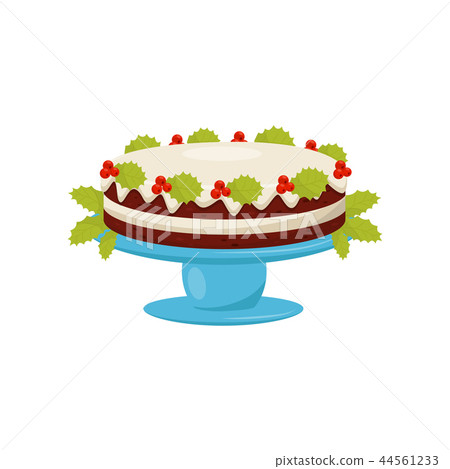 Delicious layered cake with vanilla glaze and red berries with green leaves. Traditional Christmas 44561233