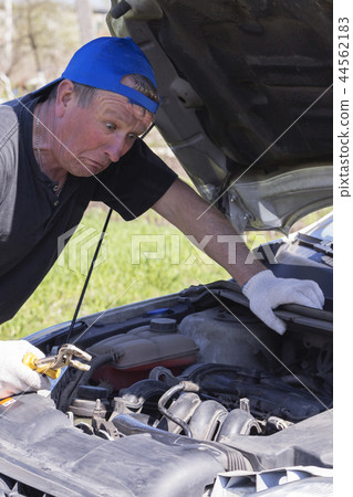 Surprised mechanic looks inside the car. Surprised mechanic looks inside the car. 44562183