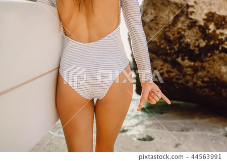 Sexy surf girl with surfboard and shaka hand Sexy surf girl with surfboard and shaka hand 44563991