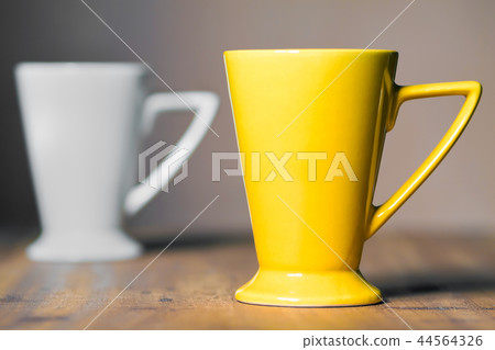Yellow mug on the desktop Yellow mug on the desktop 44564326