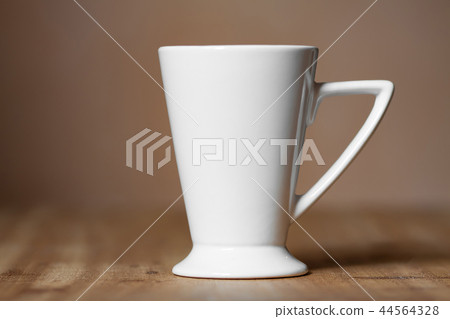 White mug on the desktop White mug on the desktop 44564328