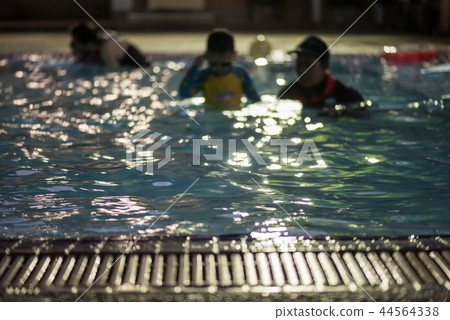 trainer practive child to swim. Blurred abstract trainer practive child to swim. Blurred abstract 44564338
