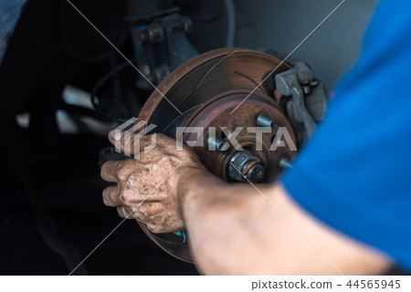 Disc brake and asbestos brake pads at car garage Disc brake and asbestos brake pads at car garage 44565945