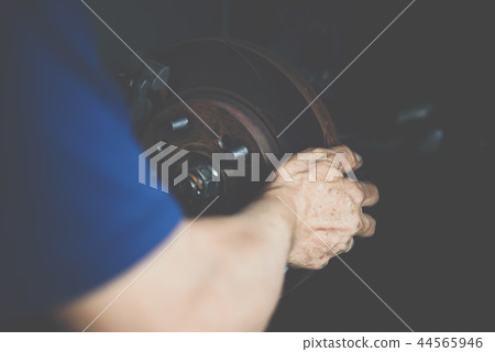 Disc brake and asbestos brake pads at car garage 44565946