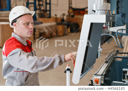 control computer display of Machine. Manufacture workers adjusts the machine in the warehouse. the 44568185