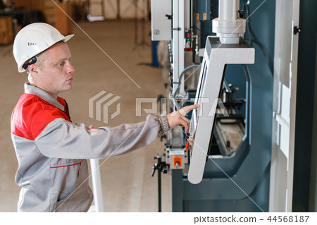 control computer display of Machine. Manufacture workers adjusts the machine in the warehouse. the control computer display of Machine. Manufacture workers adjusts the machine in the warehouse. the 44568187