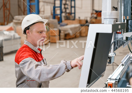 control computer display of Machine. Manufacture workers adjusts the machine in the warehouse. the 44568195