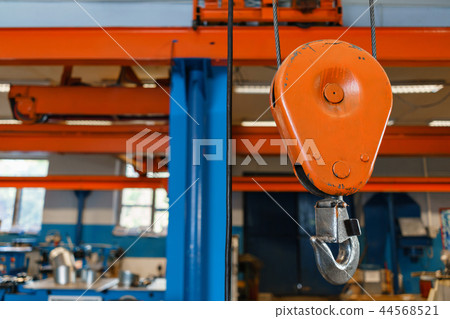 Crane hook. The system of pulleys and ropes, a hanging mechanism in the production area. Movement 44568521