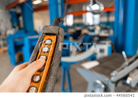 remote control of the crane on production. Workers working with a crane in the warehouse.. the remote control of the crane on production. Workers working with a crane in the warehouse.. the 44568541