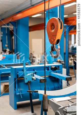 Crane hook. The system of pulleys and ropes, a hanging mechanism in the production area. Movement Crane hook. The system of pulleys and ropes, a hanging mechanism in the production area. Movement 44568579