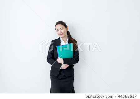 Smiling business woman holding a file Smiling business woman holding a file 44568617
