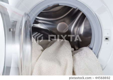 white clothes wash, open washing machine with towel closeup white clothes wash, open washing machine with towel closeup 44568692