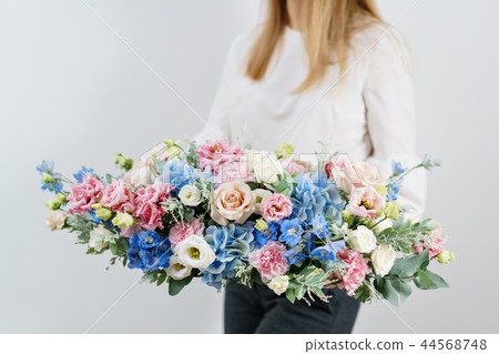 beautiful spring bouquet. Young girl holding a flowers arrangement with various of colors. white 44568748