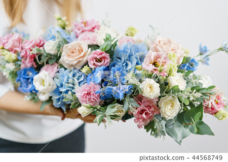 beautiful spring bouquet. Young girl holding a flowers arrangement with various of colors. white beautiful spring bouquet. Young girl holding a flowers arrangement with various of colors. white 44568749