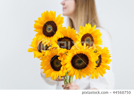 Bouquet of yellow sunflowers , flower in woman hand. Room morning. Colors of autumn and mood fall Bouquet of yellow sunflowers , flower in woman hand. Room morning. Colors of autumn and mood fall 44568750