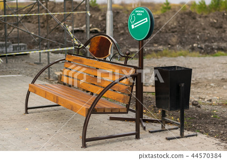 Smoking area with benches and urns Smoking area with benches and urns 44570384