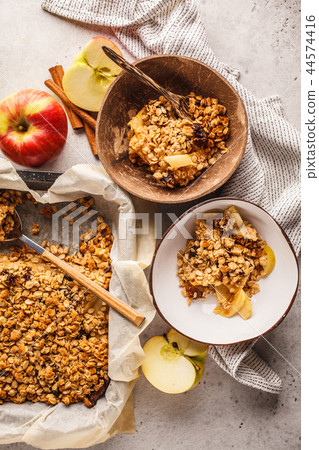 Autumn vegan apple oat crumble pie in coconut bowl Autumn vegan apple oat crumble pie in coconut bowl 44574416
