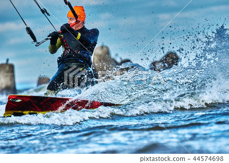 A male kiter slides on the surface of the water. A male kiter slides on the surface of the water. 44574698