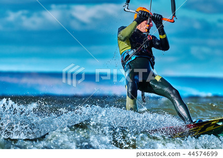 A male kiter slides on the surface of the water. A male kiter slides on the surface of the water. 44574699