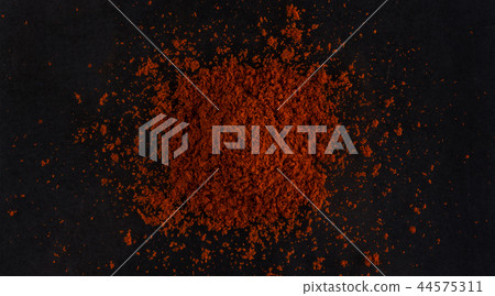 Pile of red paprika powder black background. Top view Pile of red paprika powder black background. Top view 44575311