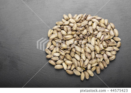pistachios on black background pistachios on black background 44575423