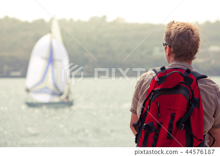 Man looks at sailboat Man looks at sailboat 44576187