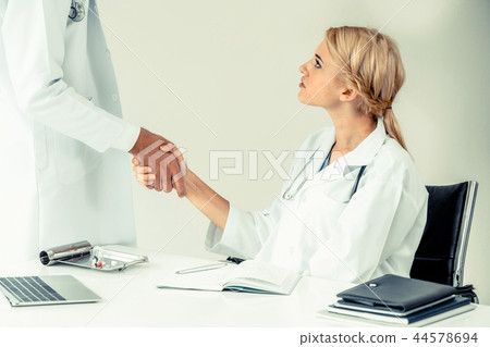 Doctor at hospital shakes hand with another doctor 44578694