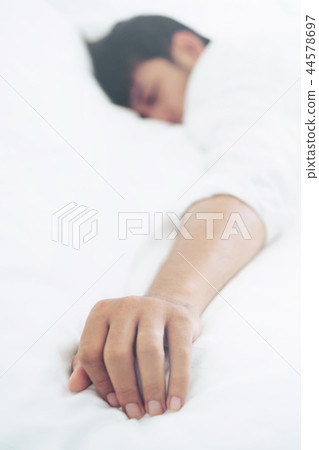 Young man sleep in bed in the bedroom. Young man sleep in bed in the bedroom. 44578697