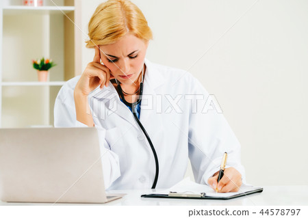 Serious doctor working in hospital office. Serious doctor working in hospital office. 44578797