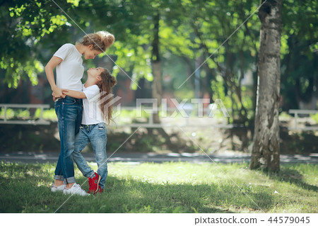 daughter kisses mom / happy family mom and daughter kiss, concept of female happiness, beautiful mother and daughter 5 year old kiss daughter kisses mom / happy family mom and daughter kiss, concept of female happiness, beautiful mother and daughter 5 year old kiss 44579045