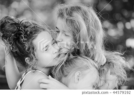 daughter kisses mom / happy family mom and daughter kiss, concept of female happiness, beautiful mother and daughter 5 year old kiss 44579192