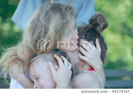 daughter kisses mom / happy family mom and daughter kiss, concept of female happiness, beautiful mother and daughter 5 year old kiss daughter kisses mom / happy family mom and daughter kiss, concept of female happiness, beautiful mother and daughter 5 year old kiss 44579347