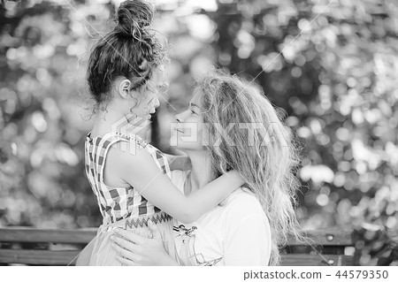 daughter kisses mom / happy family mom and daughter kiss, concept of female happiness, beautiful mother and daughter 5 year old kiss daughter kisses mom / happy family mom and daughter kiss, concept of female happiness, beautiful mother and daughter 5 year old kiss 44579350