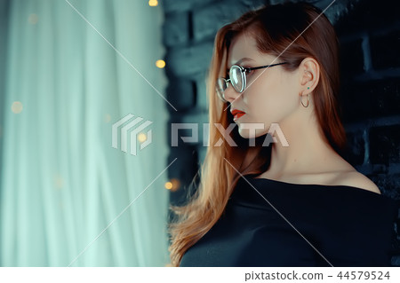 red-haired happy girl wearing glasses / business woman concept, confident, successful girl with glasses. Sight, training, European business. red-haired happy girl wearing glasses / business woman concept, confident, successful girl with glasses. Sight, training, European business. 44579524