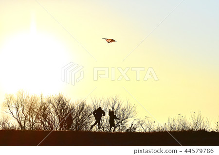 Family with kite flying and first sunrise 44579786