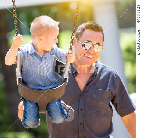 Young Boy Having Fun With His Father At The Park Young Boy Having Fun With His Father At The Park 44579823