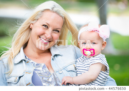 Caucasian Mommy and Daughter Portrait In The Park 44579830