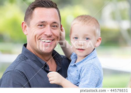 Young Boy Having Fun With His Father At The Park Young Boy Having Fun With His Father At The Park 44579831