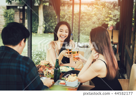 Teeneger asian friends clinking glasses 44582177