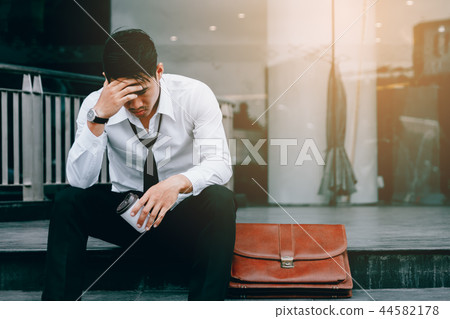Asian young businessman stress sitting in front Asian young businessman stress sitting in front 44582178