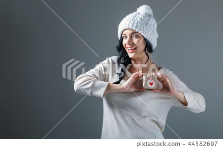 Young woman holding a gift box Young woman holding a gift box 44582697