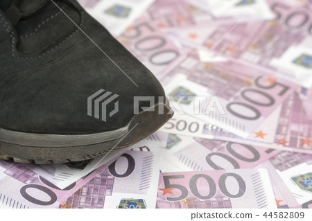 Foot stepped on euro money 44582809