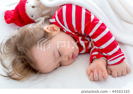 Toddler boy sleeping in his house at Christmas time Toddler boy sleeping in his house at Christmas time 44583185