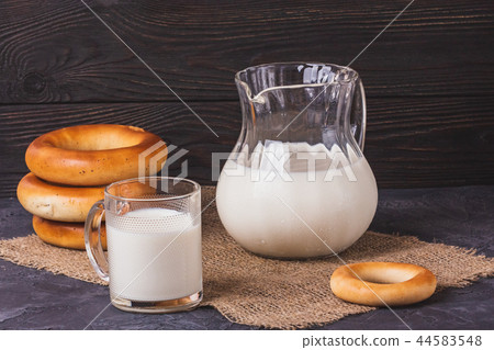 Milk in jug and cup of fresh bagels for breakfast Milk in jug and cup of fresh bagels for breakfast 44583548