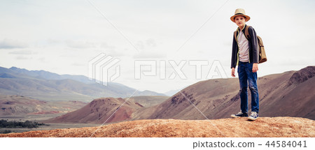 boy is traveler with backpack standing on mountain boy is traveler with backpack standing on mountain 44584041