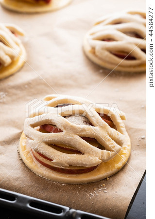 Cooking process of galetta, biscuit with apples on paper background. Apple pie with cinnamon. 44584277